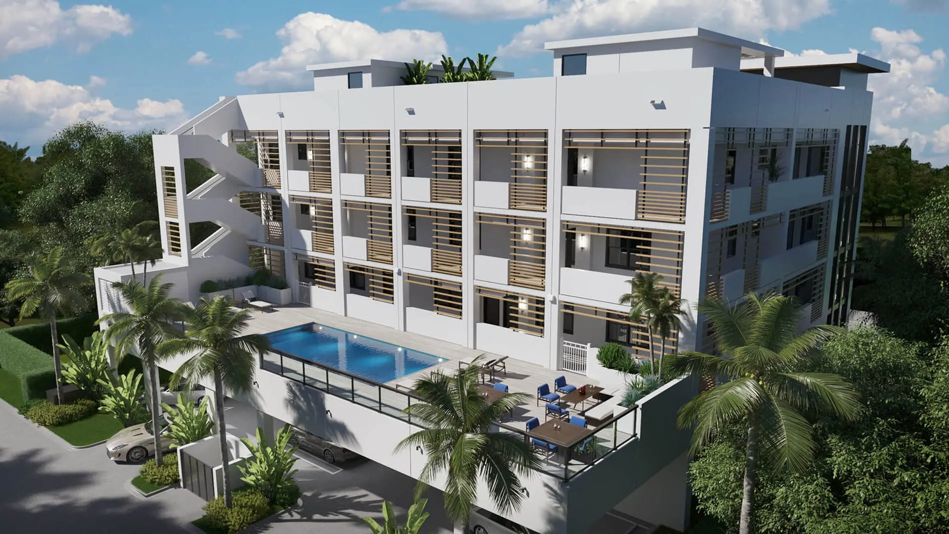 Elevated pool deck with lounge seating at a modern white condo building featuring wood accent panels and palm trees.